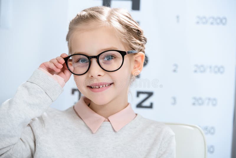 adorable smiling child looking at camera in glasses at oculist royalty free stock images adorable smiling child looking at camera in glasses at oculist royalty free stock images
