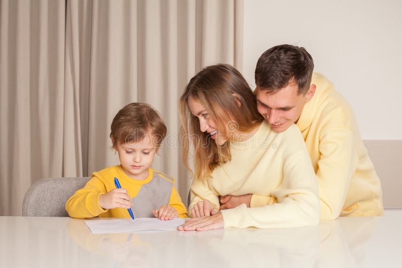 Adorable Smiling Family, Parents in Yellow Clothes with Their Son ...