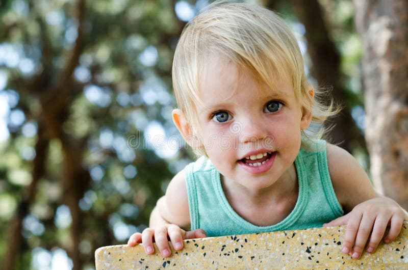 Adorable toddler girl looking right in camera shallow focus