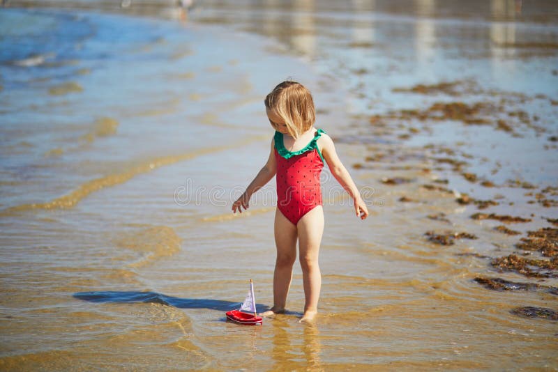 Little Girl in Red Swimsuit Playing in the Sea Stock Image - Image of ...