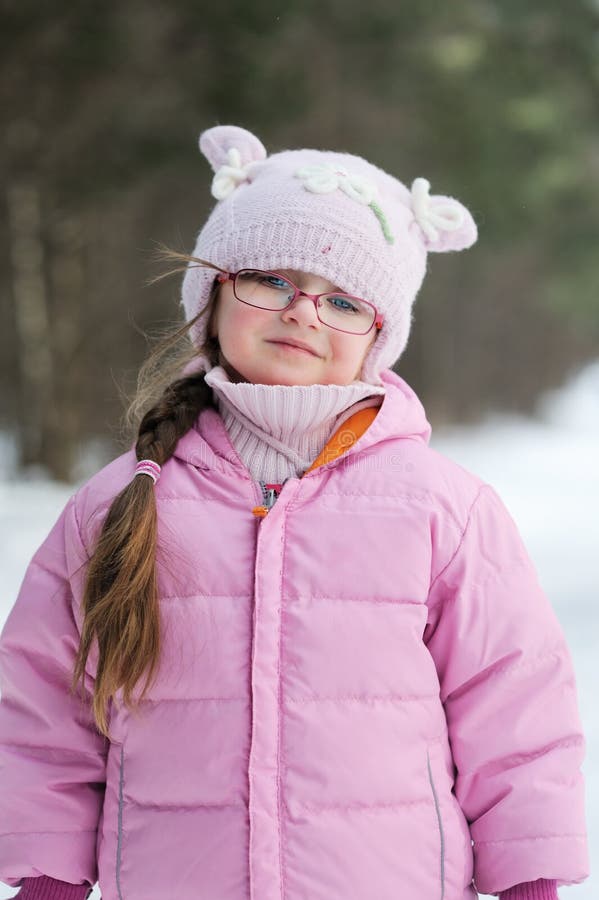 Adorable winter small girl in glasses