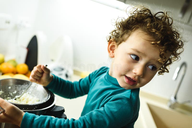 Adorable 2 Year Old Girl Cooking a Cake at Home Overnight Stock Photo
