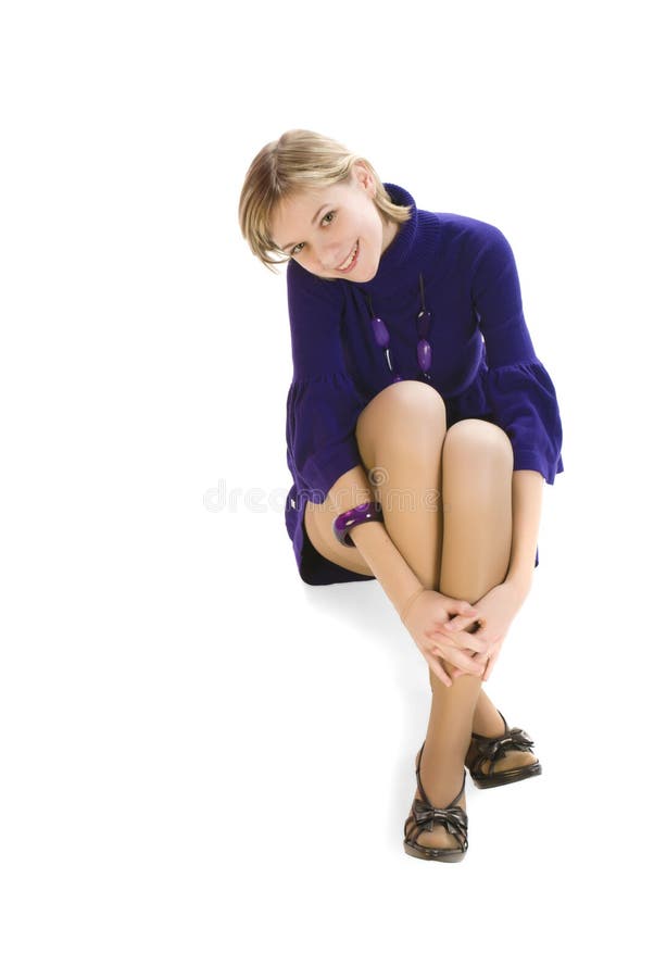 Adorable young woman sitting on the floor