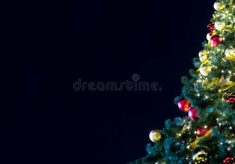 Adornado con el árbol festivo del árbol de navidad rojo de oro de las bolas en un fondo de un cielo nocturno oscuro con el espaci fotos de archivo libres de regalías Adornado con el árbol festivo del árbol de navidad rojo de oro de las bolas en un fondo de un cielo nocturno oscuro con el espaci fotos de archivo libres de regalías