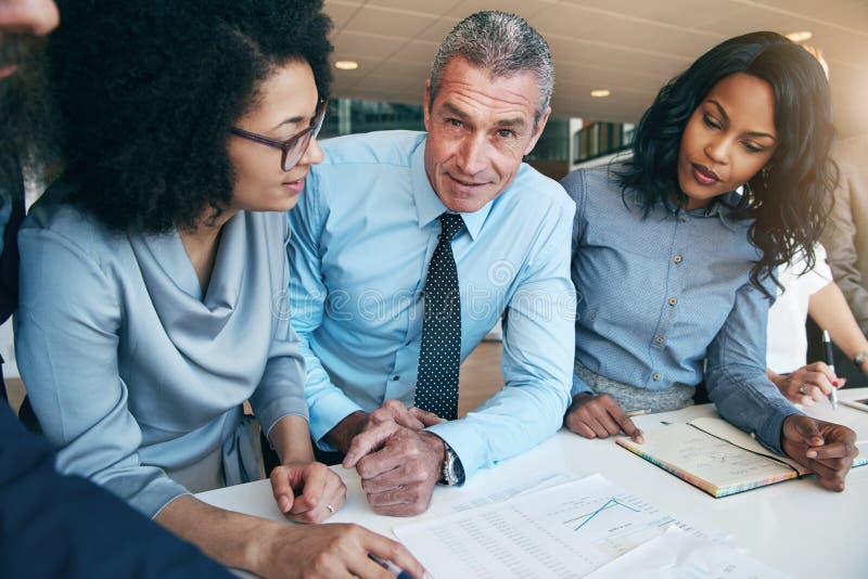 People planning strategy in office and looking at camera stock images People planning strategy in office and looking at camera stock images