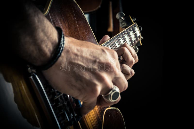 Adult caucasian guitarist portrait playing electric guitar on grunge background. Close up instrument detail. Music royalty free stock images Adult caucasian guitarist portrait playing electric guitar on grunge background. Close up instrument detail. Music royalty free stock images