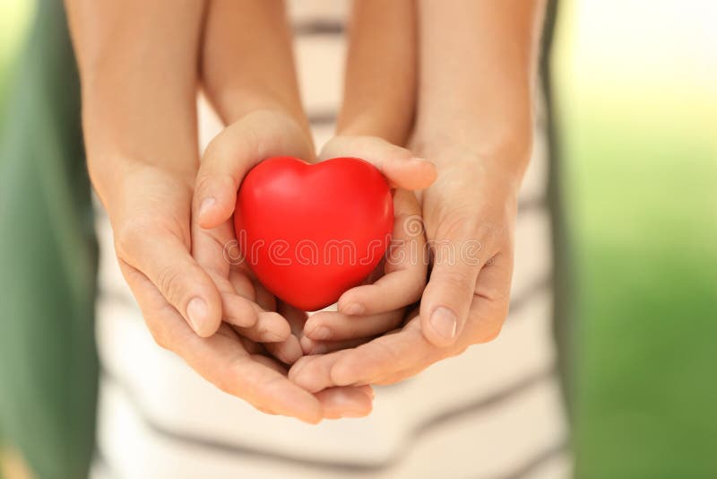 Adult and child hands holding heart royalty free stock photo