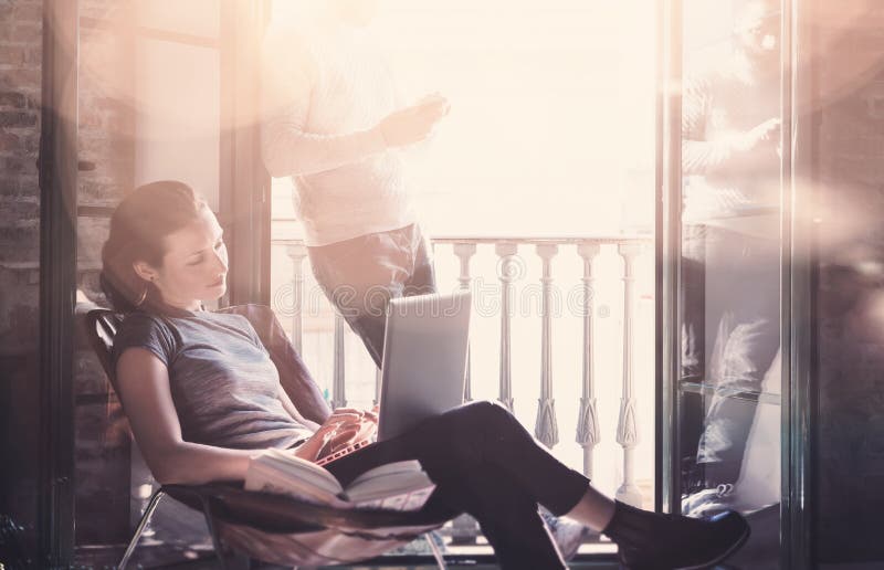 Adult couple work together. Photo woman and bearded man working with new startup project in modern loft. Using stock images Adult couple work together. Photo woman and bearded man working with new startup project in modern loft. Using stock images