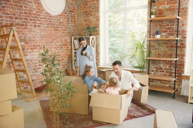 Adult family moved to a new house or apartment stock photos Adult family moved to a new house or apartment stock photos