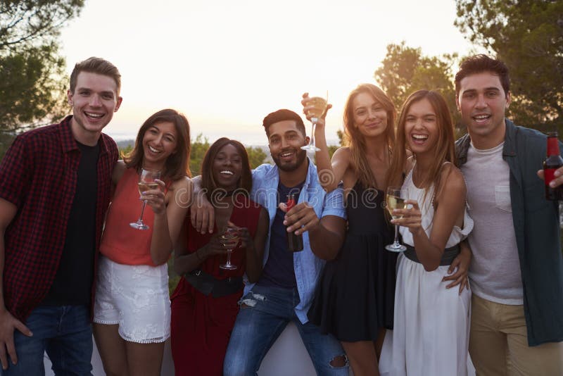 Adult Friends at a Party on a Rooftop Looking To Camera Stock Image ...