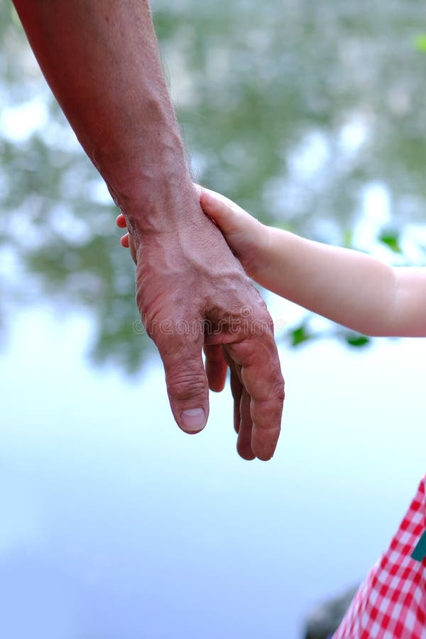 Adult Male Hands Holding Kid Hands, Family Help Care Concept