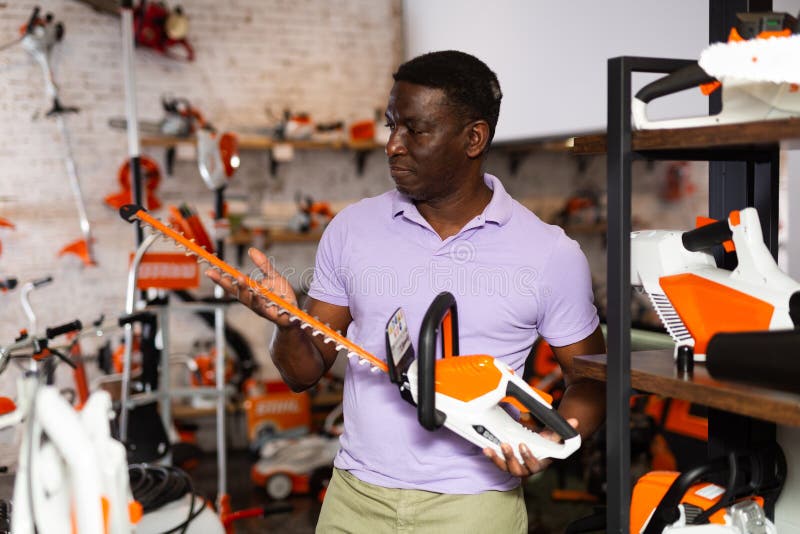 Adult Man with an Brush Cutter in Hardware Store Stock Photo Image of