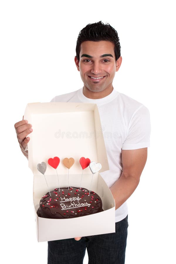 Adult man holding a chocolate birthday cake.