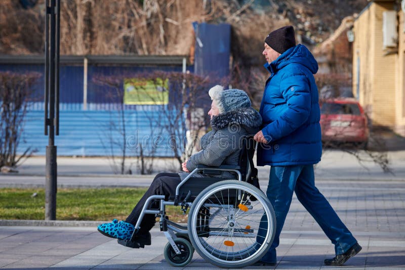 Adult Man Rolls His Disabled Mother On Wheelchair Careful Relationships With Disabled Person