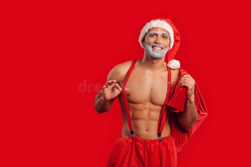 Adult Santa Claus posing, holding sack full of presents