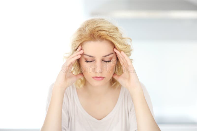 Adult woman having headache at home