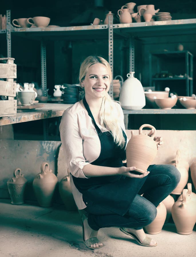 Adult woman potter carrying ceramic vessels stock photos Adult woman potter carrying ceramic vessels stock photos