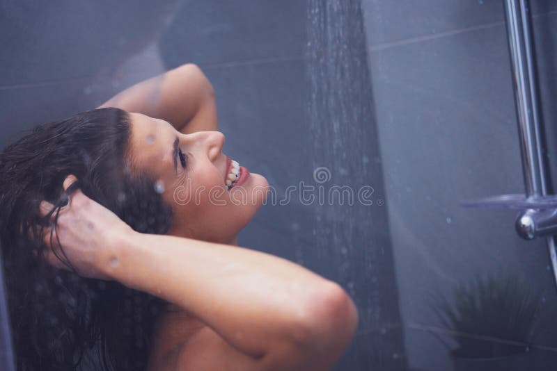 Adult woman under the shower in bathroom