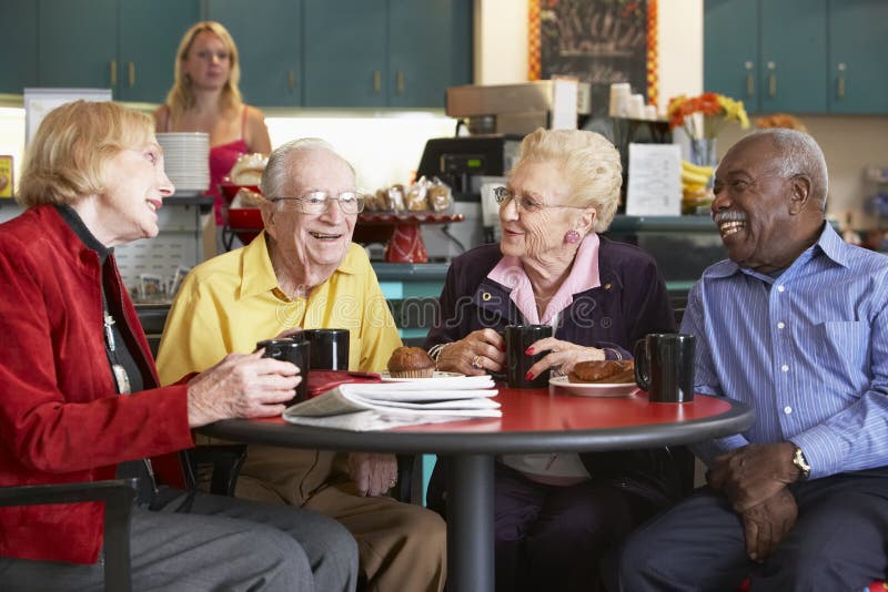 Senior adults having morning tea in cafeteria. Senior adults having morning tea in cafeteria