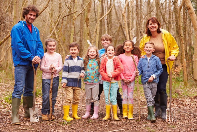 Adults And Children Playing Adventure Game In Forest