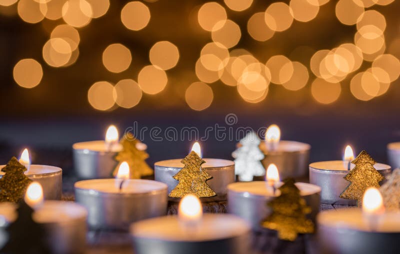 Advent and christmas background with candlelight, blurred lights and ornaments