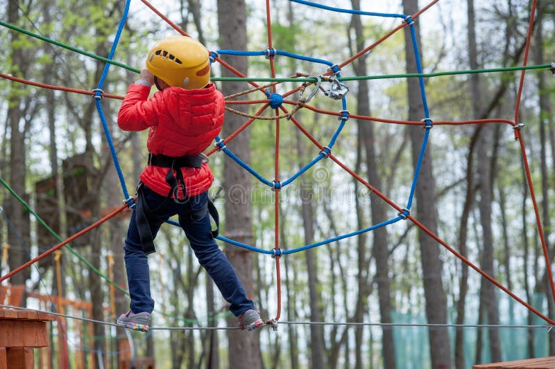 Adventure climbing high wire park - people on course in mountain helmet and safety equipment stock photos Adventure climbing high wire park - people on course in mountain helmet and safety equipment stock photos