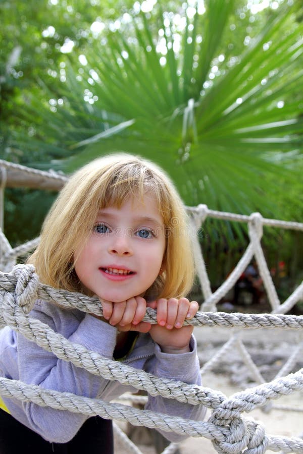 Adventure little girl on jungle park rope bridge