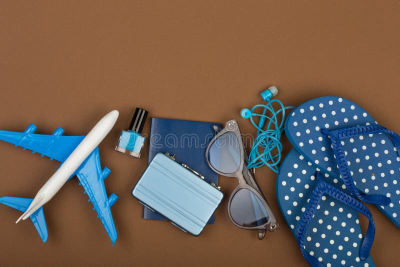 Adventure time - plane, flip flops, passport, little suitcase, sunglasses, nail polish stock photos Adventure time - plane, flip flops, passport, little suitcase, sunglasses, nail polish stock photos