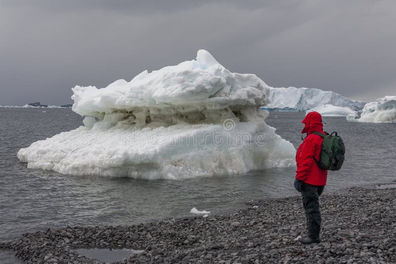 An adventure tourist near a small iceberg on Paulet Island in Antarctica. An adventure tourist near a small iceberg on Paulet Island in Antarctica