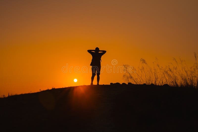 Wanderlust and adventure travel from silhouette man hiking and stand on top of the mountain in summer season