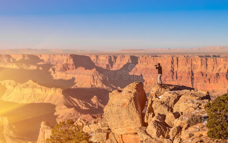 Adventurous man taking a photo at Grand Canyon bef