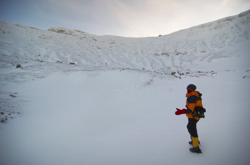 Climber descending from the mountains in the morning. Bucegi - Romania in background highest part of Morarului Valley and glacier. On top Omu shelter and meteorological station. Adventurer adventure stock images, royalty-free photos and pictures