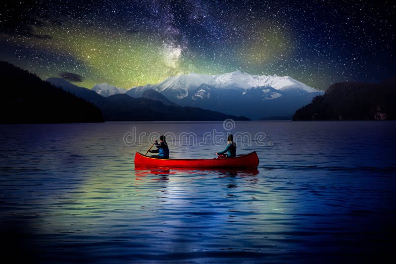 Adventurous People on a Red Canoe in a Lake.