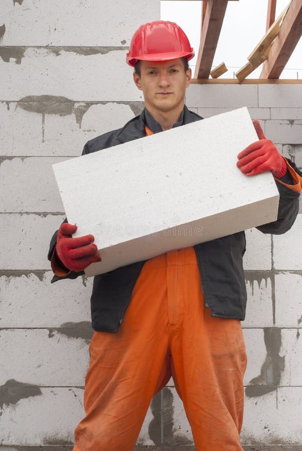 Mason Aligning Aerated Autoclaved Concrete Block Of Constructed House