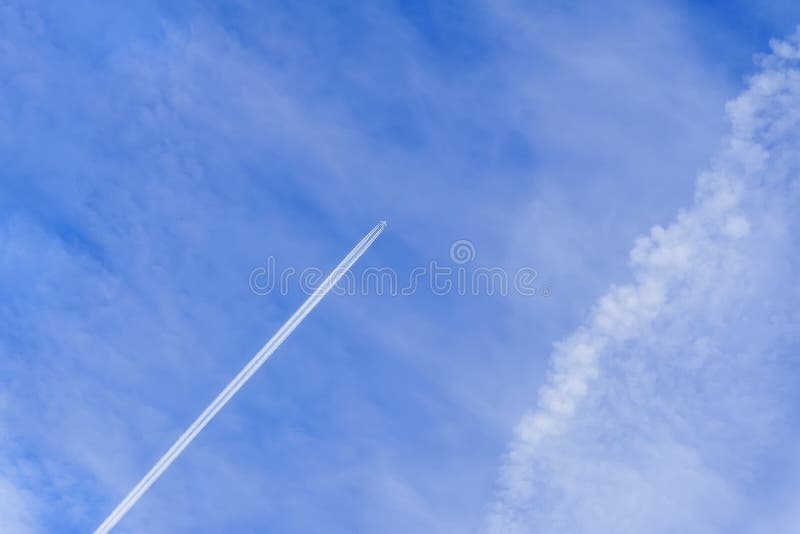Aereo e traccia, percorsi di condensazione, percorsi di vapore Sfondo del cielo azzurro luminoso con traccia del piano del getto fotografia stock libera da diritti Aereo e traccia, percorsi di condensazione, percorsi di vapore Sfondo del cielo azzurro luminoso con traccia del piano del getto fotografia stock libera da diritti