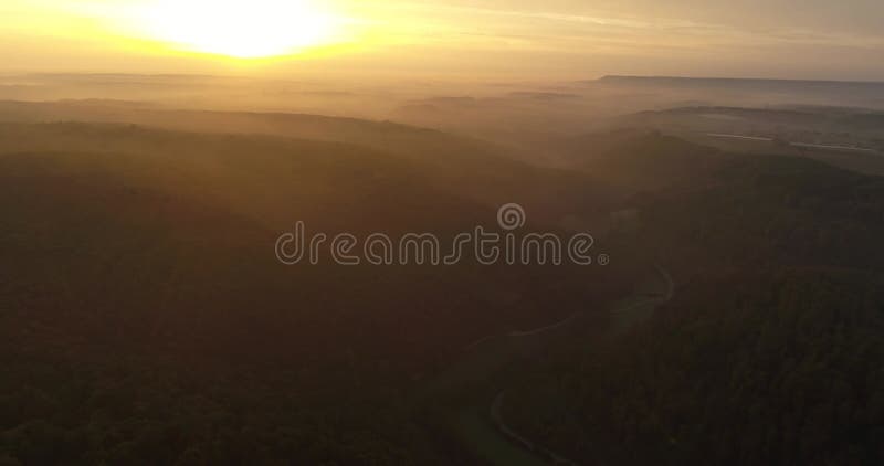 Aerial copter flight over beautiful greeny mountains covered with fog during the sunset in Heilbronn, Germany. 4k