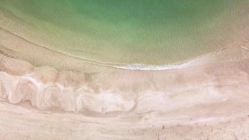 Aerial drone footage of serene sea waves and beach. Ocean view 4K.