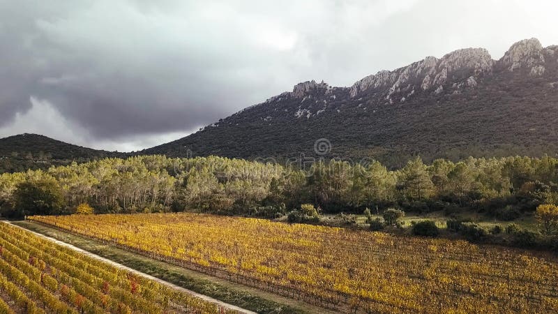 Aerial Drone Footage View: Flight between cloudy mountains with forests. Pic Saint Loup, Hortus, France, Europe. Majestic landscap