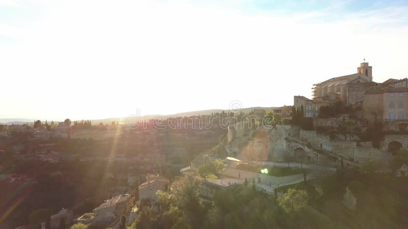 Aerial drone view of Gordes, labelled Most Beautiful Villages of France, perched on a rocky outcrop at the end of the Vaucluse pla