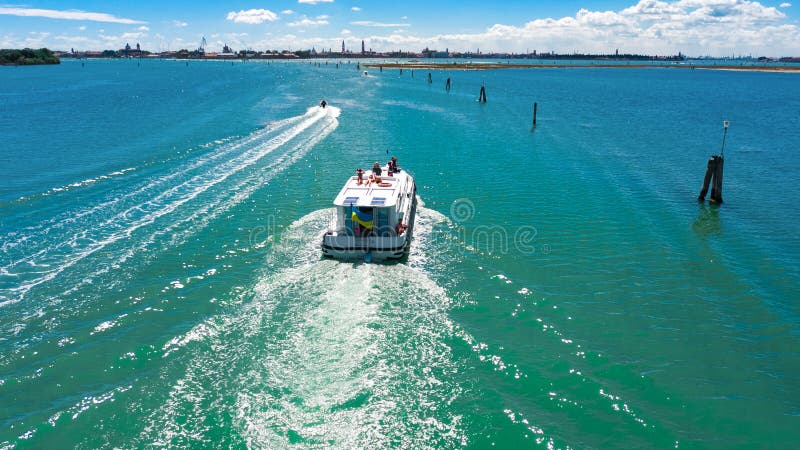 Aerial drone view of houseboat in Venetian lagoon, family travel cruise by vacation boat in Italy