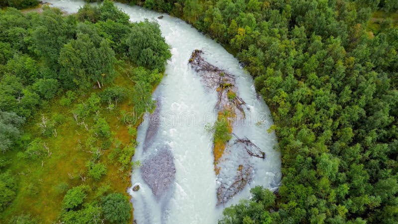 Aerial view of green valley with river through forest and glacier mountains in Vestlandet, Norway stock video