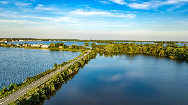 Aerial drone view of motorway road and cycling path on polder dam, cars traffic, North Holland, Netherlands