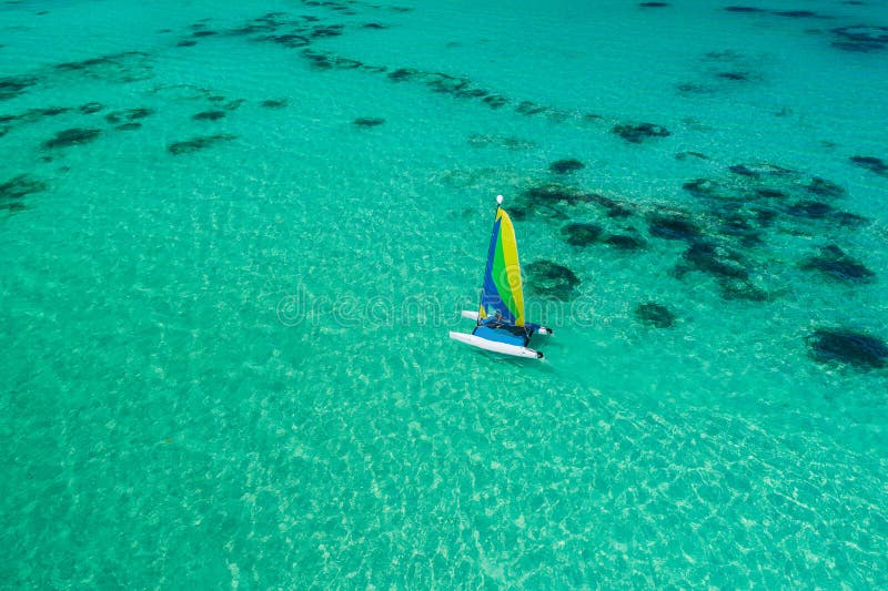 Aerial drone view of sailing sailboat surf or catamaran in turquoise water of Caribbean sea near Punta Cana beach stock photos Aerial drone view of sailing sailboat surf or catamaran in turquoise water of Caribbean sea near Punta Cana beach stock photos