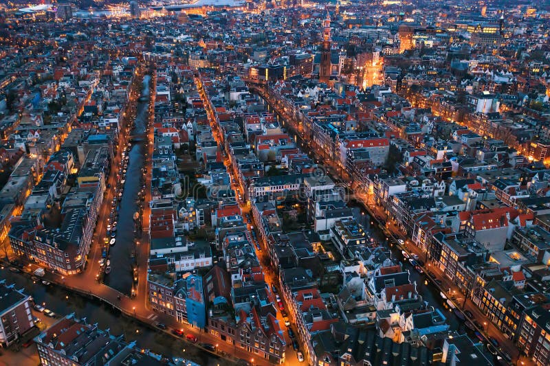 Aerial evening Amsterdam view with narrow canals, streets and historic buildings, view from above, Netherlands