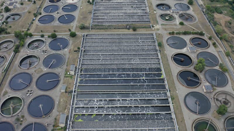 Aerial flying over of a water treatment plant facility. Aeration station. Round sedimentation tanks. Sewage treatment