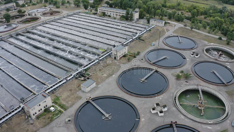 Aerial flying over a water treatment plant facility. Aeration station. Round sedimentation tanks. Sewage treatment plant