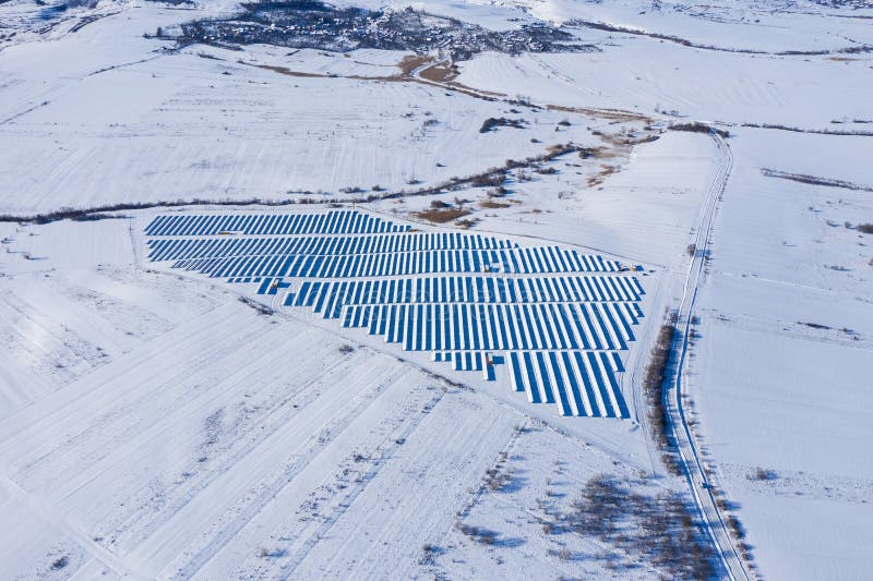 Aerial image of snow covered solar panel park