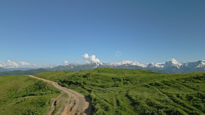 Aerial of lone man traveler in alpine meadows of Svaneti mountains. Trekking in remote nature. Highlights solitude stock video footage