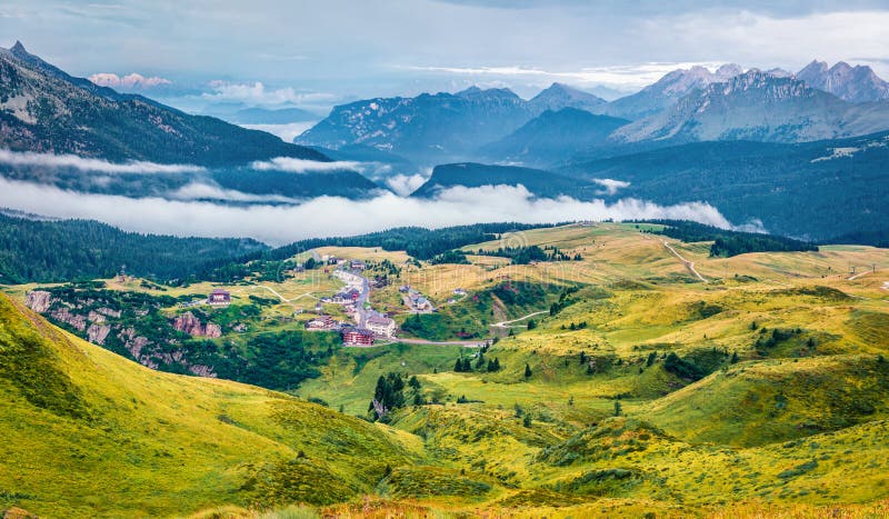 Aerial morning view of the top of Rolle pass. Picturesque summer scene of Dolomites. Foggy landscape of mountain valley, Trentino