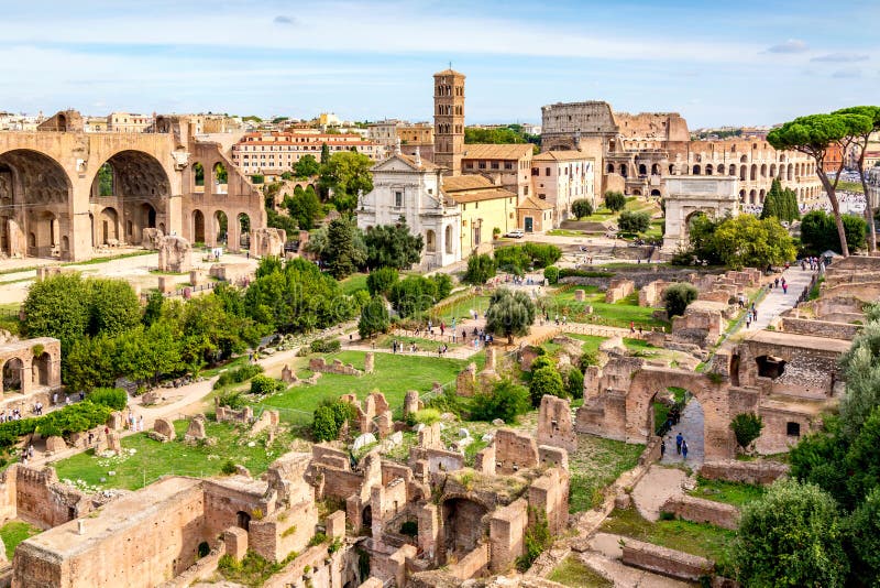 Aerial panoramic cityscape view of the Roman Forum and Roman Colosseum in Rome, Italy. World famous landmarks in Italy during